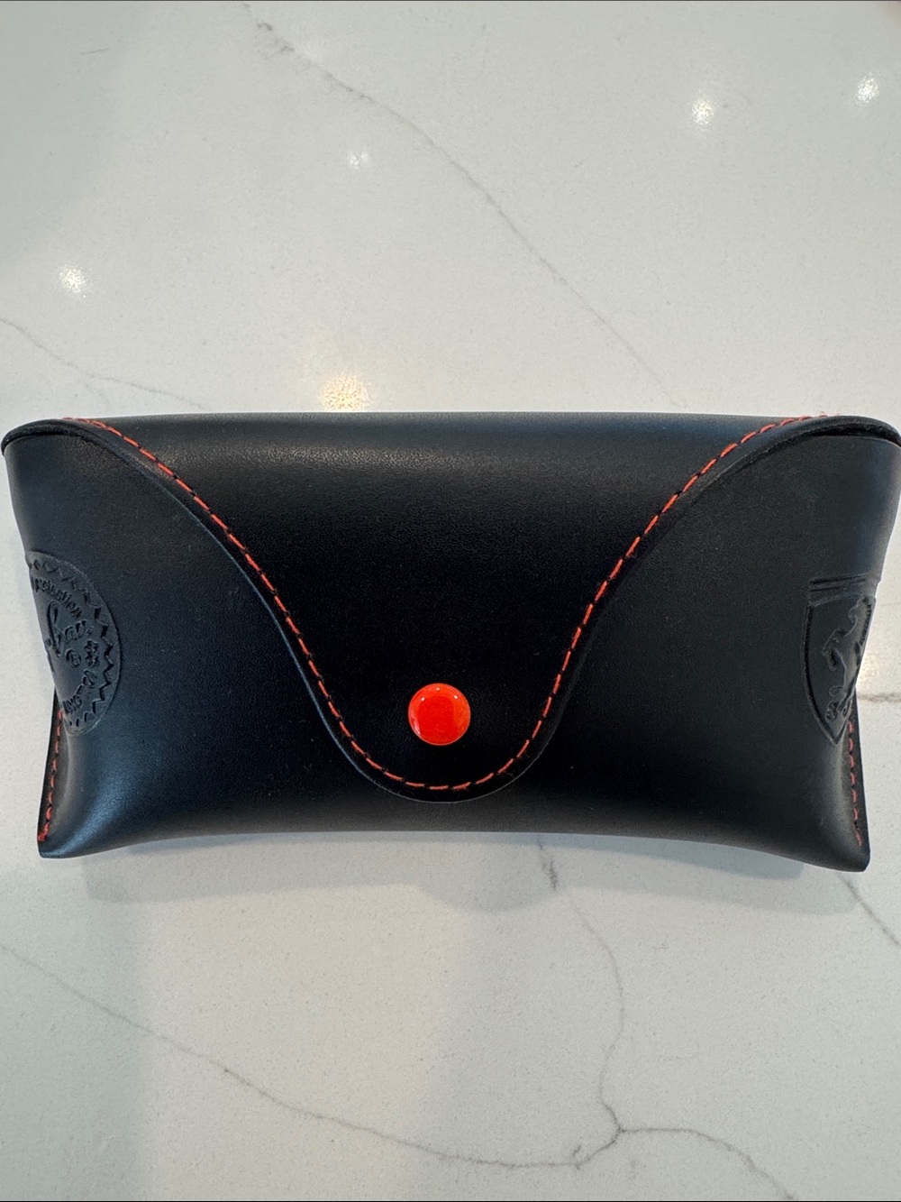 This is a black leather Ray-Ban x Scuderia Ferrari sunglasses case